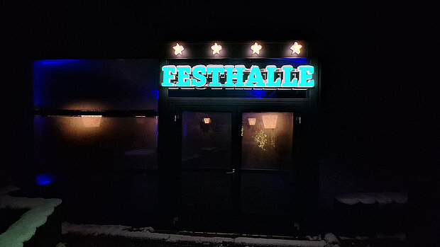 Eingang der Festhalle außen bei Nacht